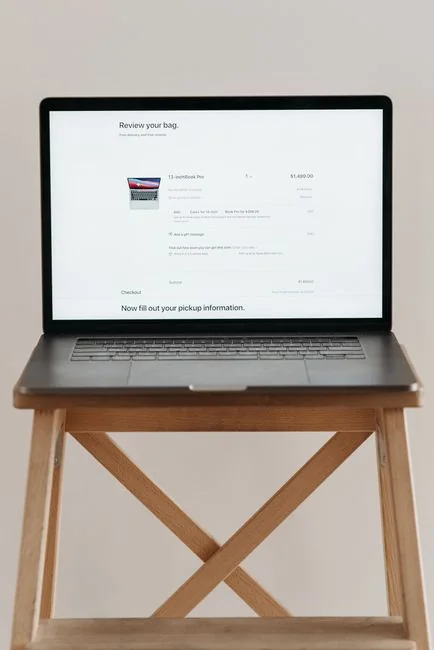 A cozy office setup featuring Christmas decor, a mug, and a laptop screen displaying a website.